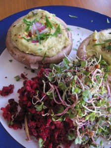 Stuffed Guacamole Portobellos with salad and sprouts